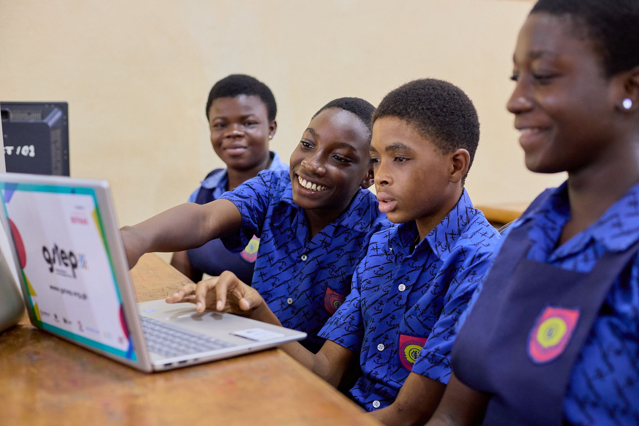 A group of four children working on a computer
