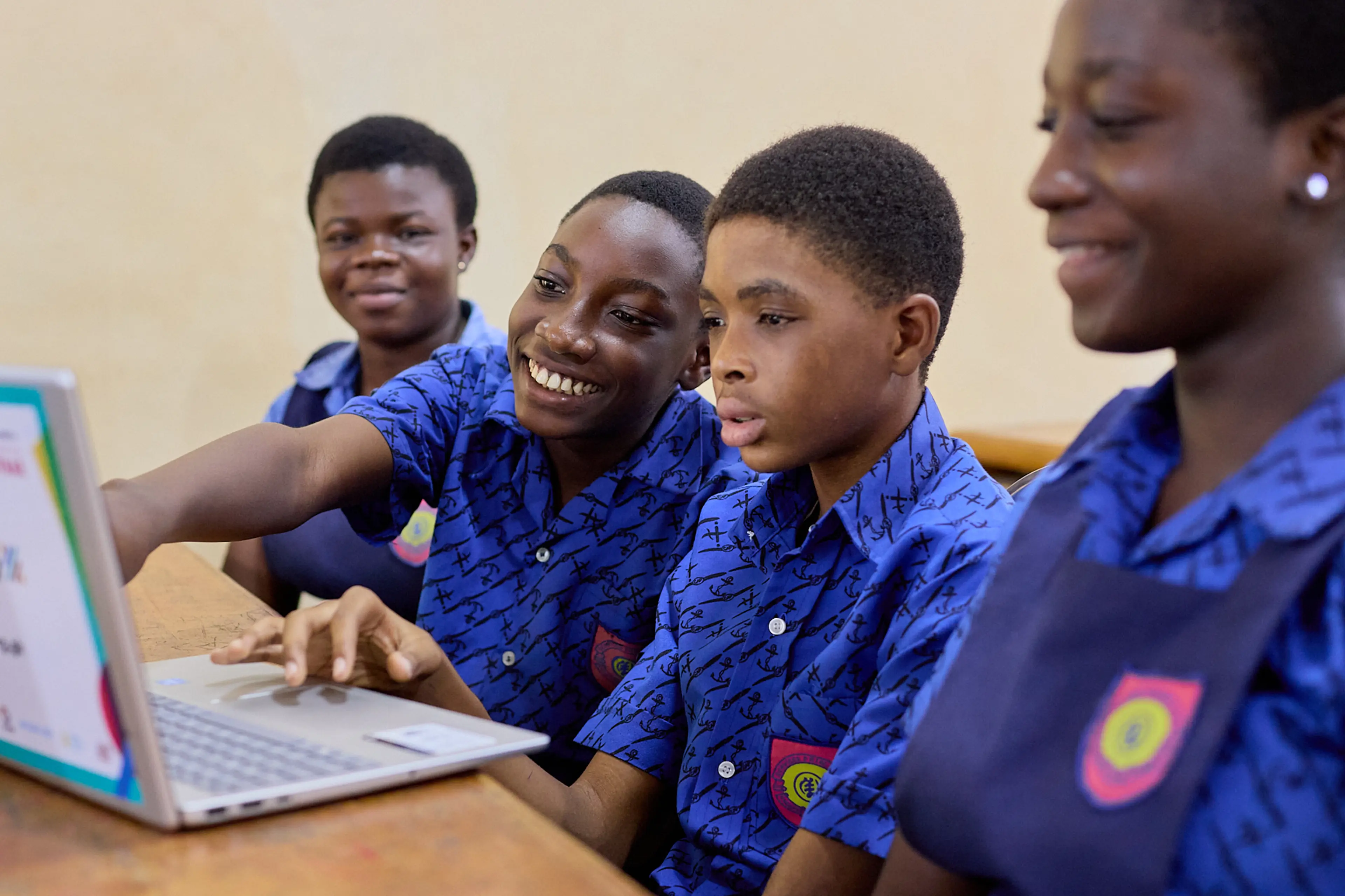A group of four children working on a computer