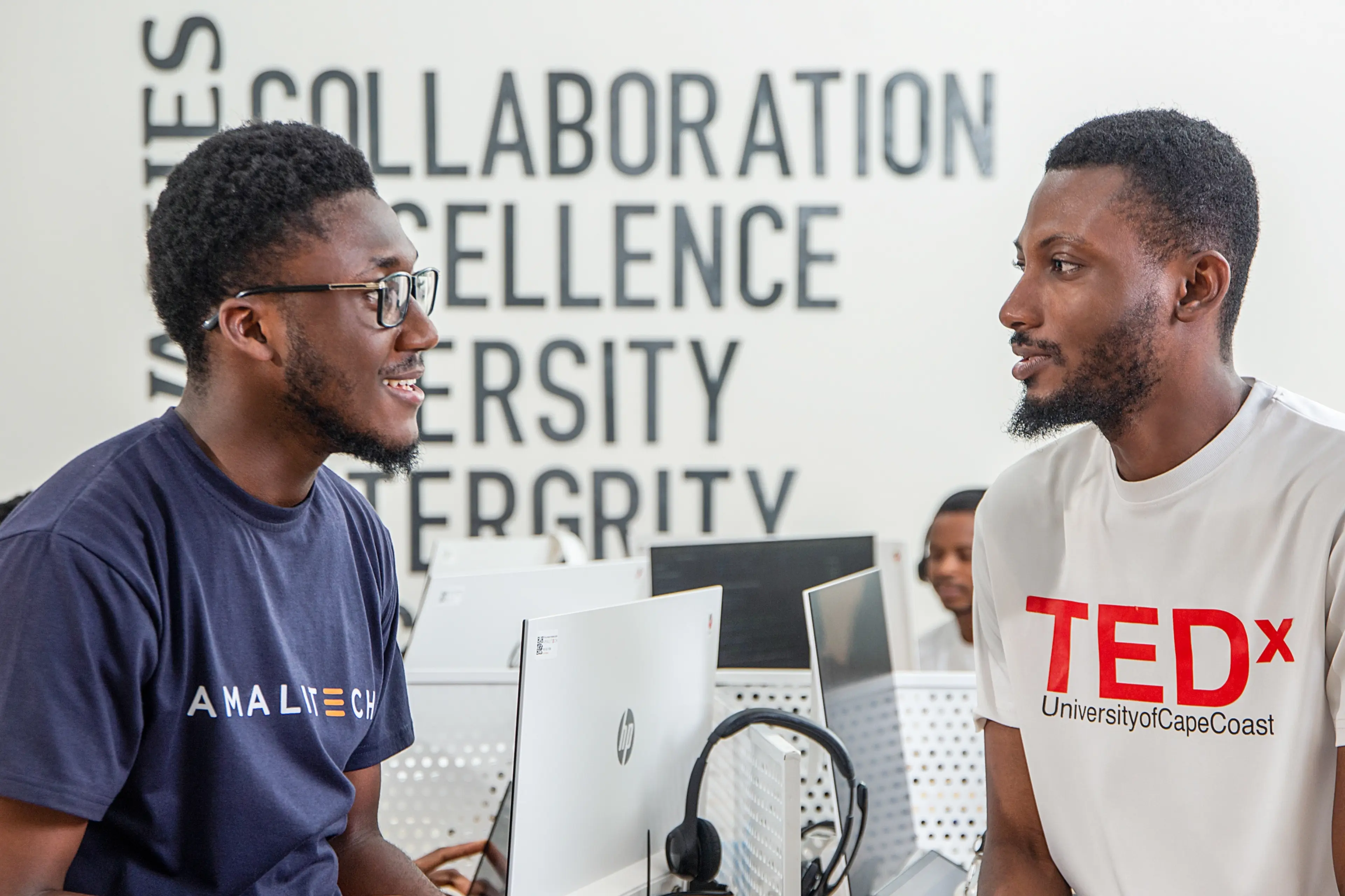 Two men sitting on a table, talking