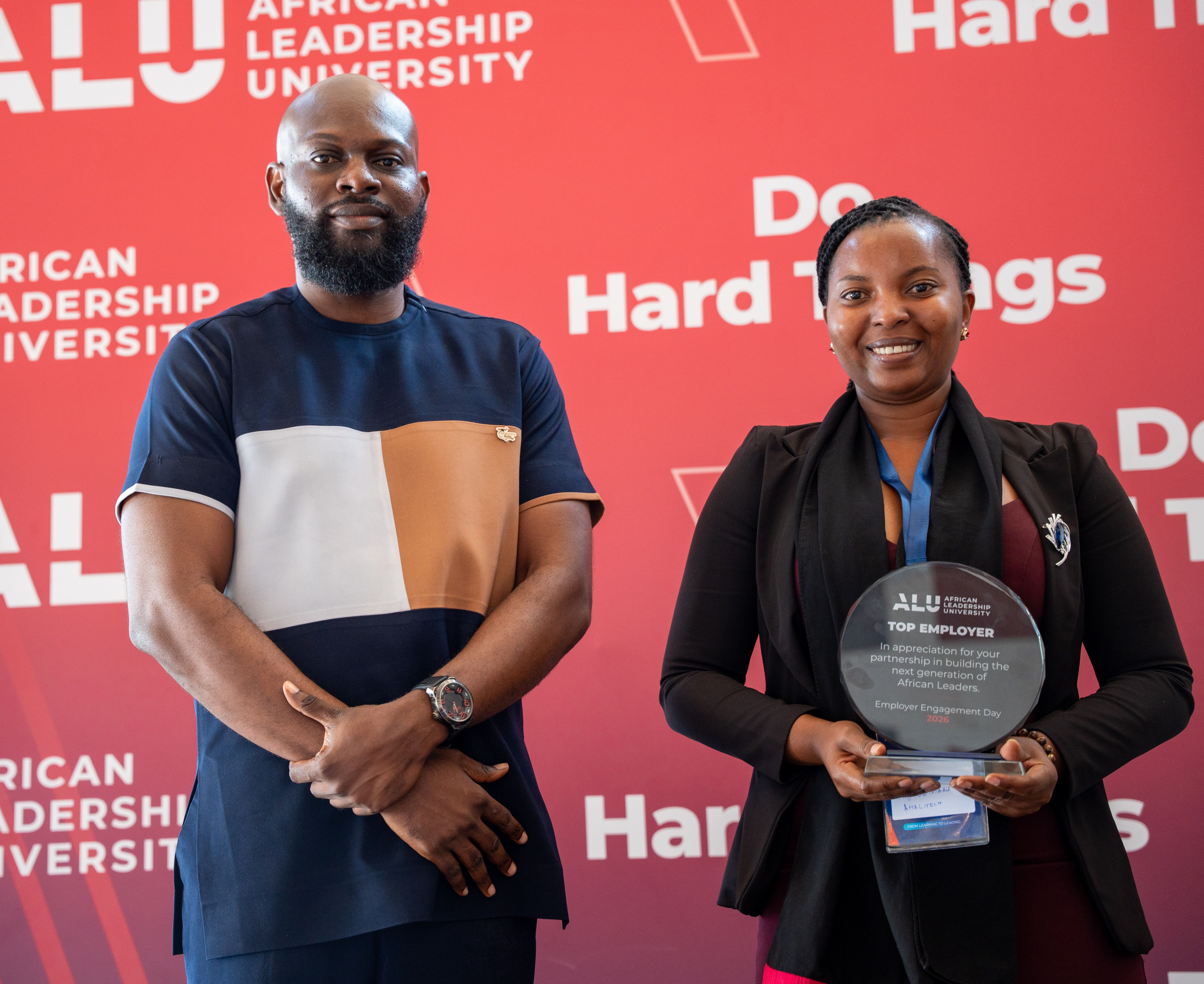 Two people with a trophy