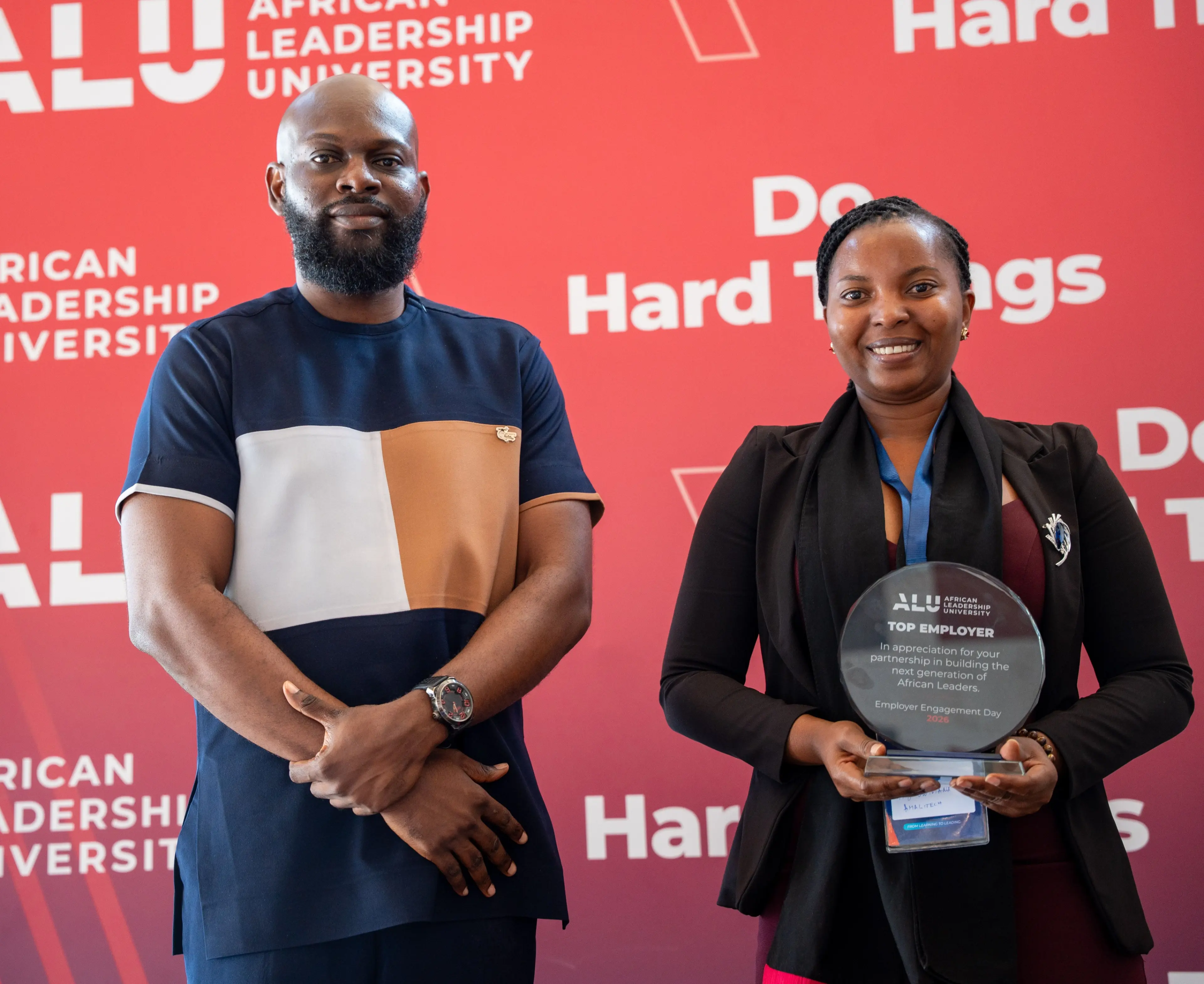 Two people with a trophy