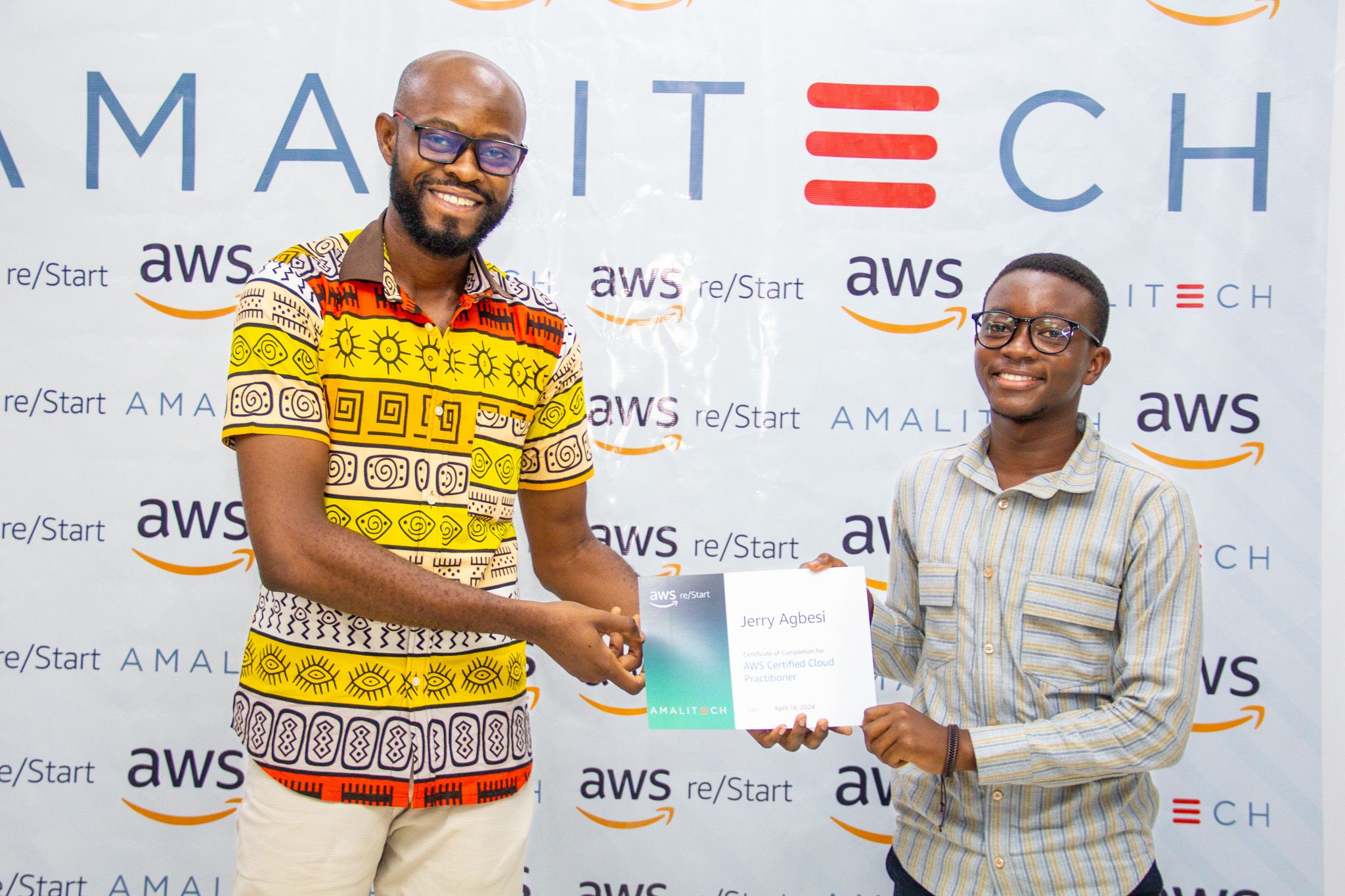 a man presenting a certificate to another young man