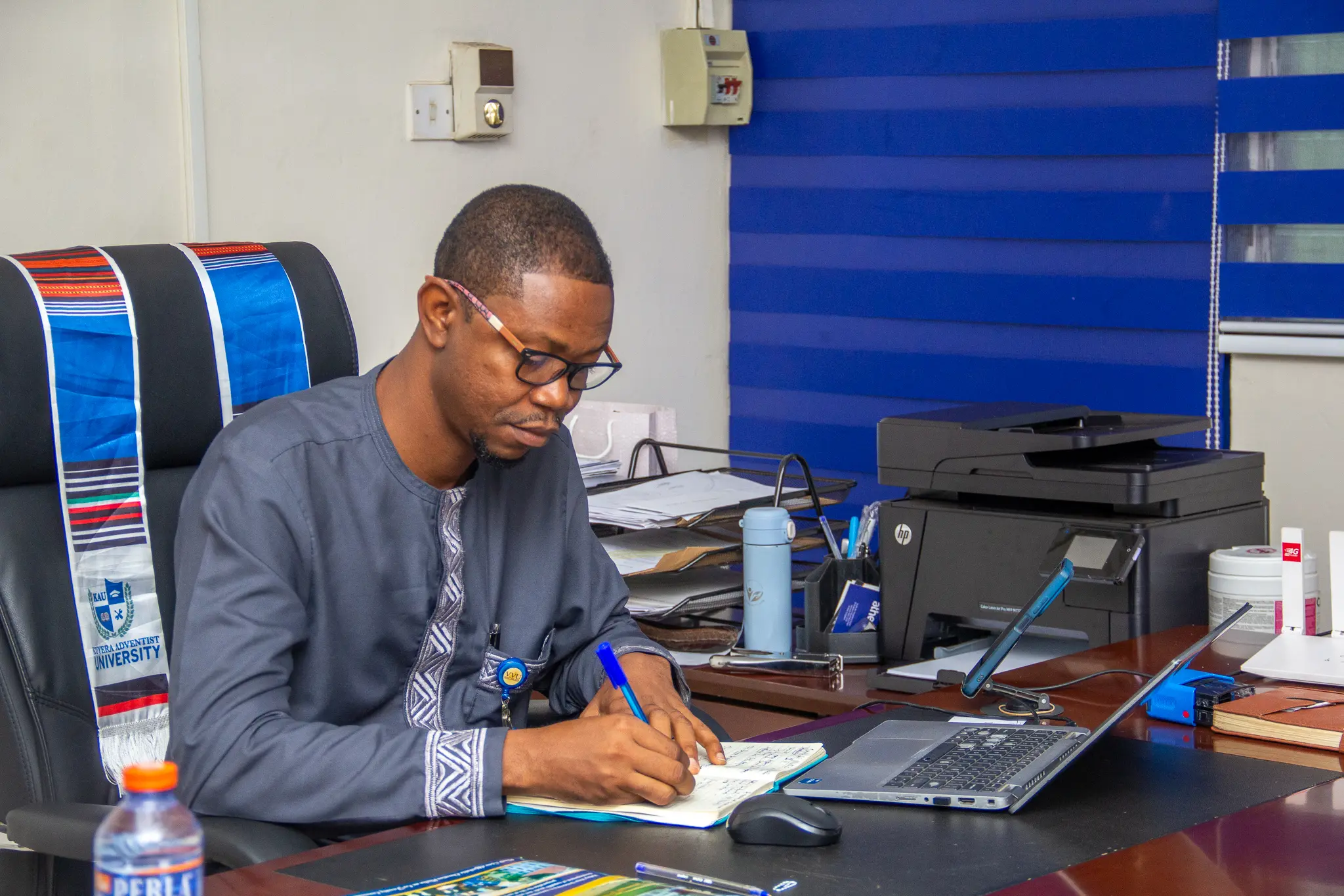 Registrar of Valley View University signing an MoU