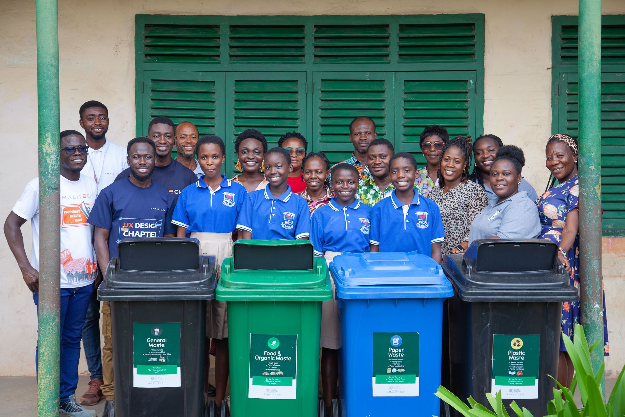 A group of students and AmaliTech employees holding AmaliTech placards as part of Green Ghana Day event