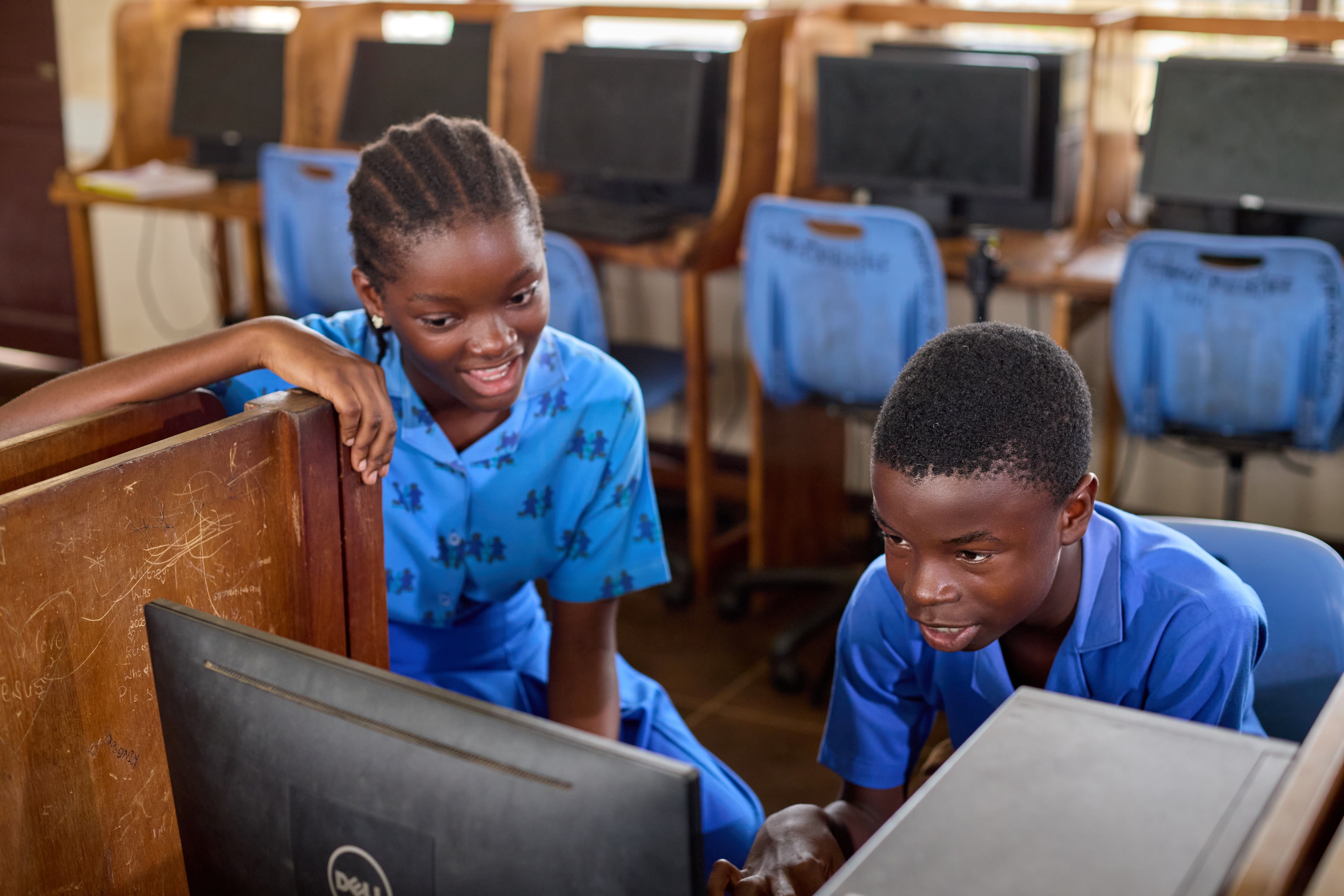Two children working on a computer