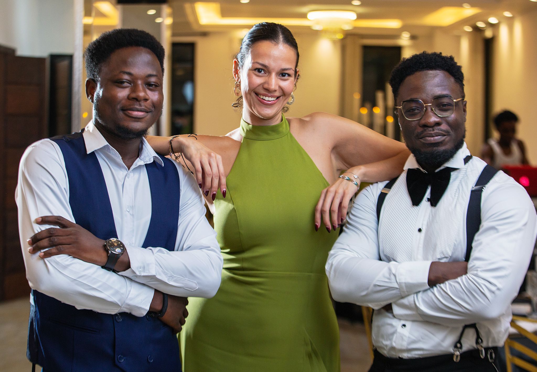 a lady in the midst of two men posing for the camera