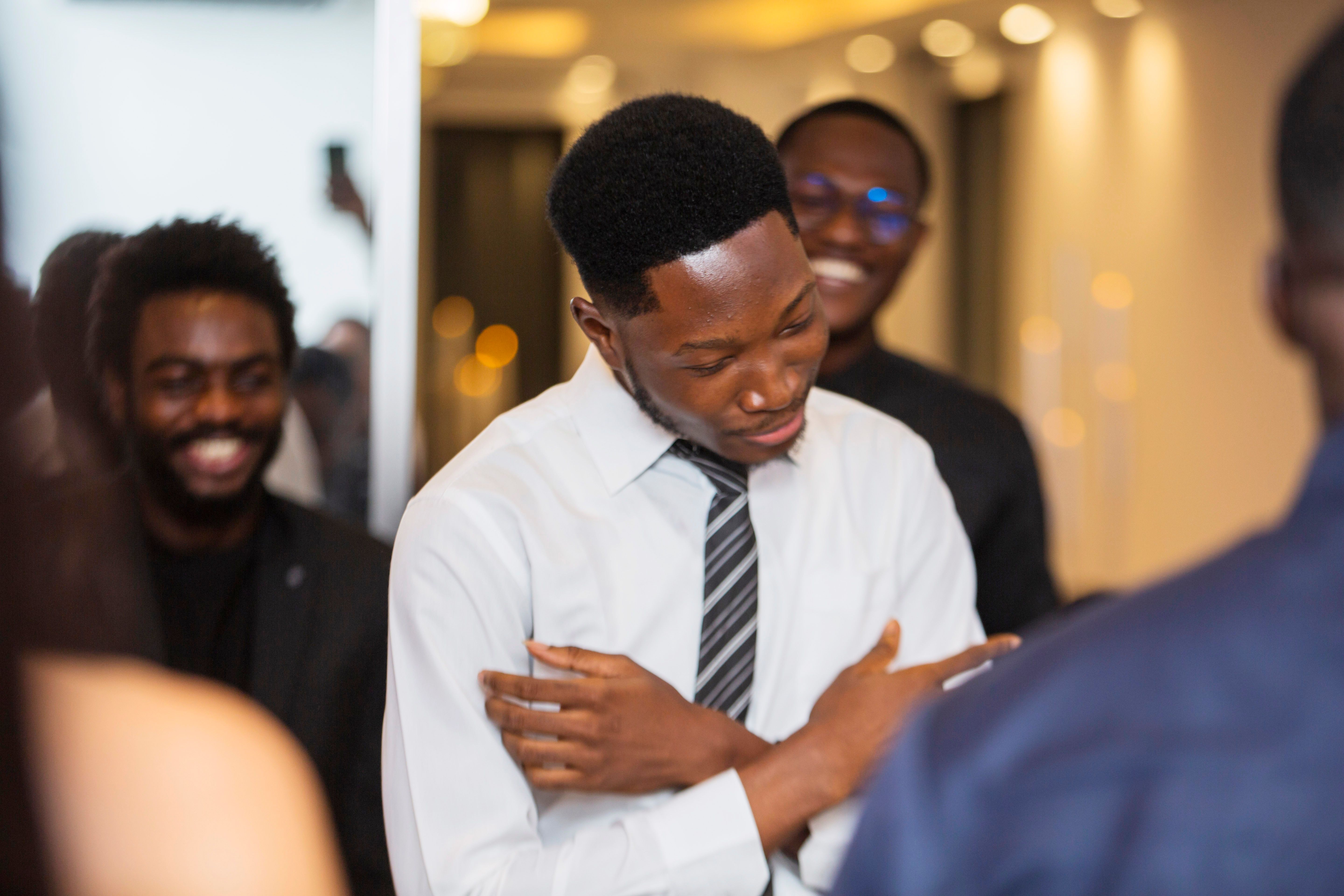 a young guy dancing and surrounded by other people