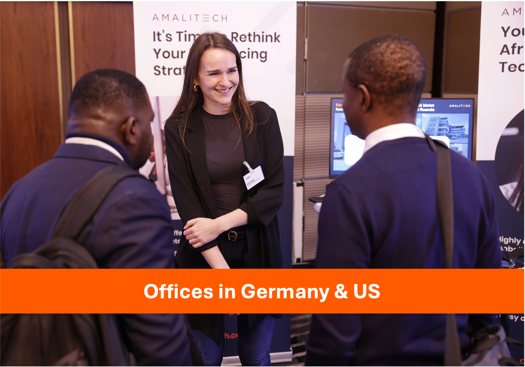 a women at an event, smiling at two booth visitors
