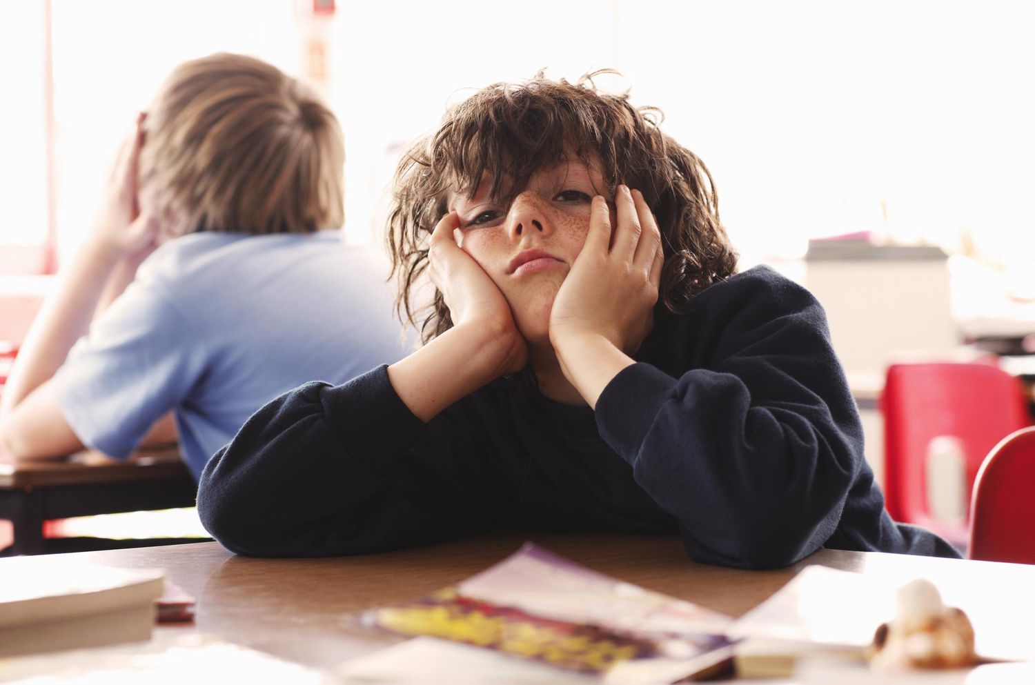 a boy bored and looking towards you