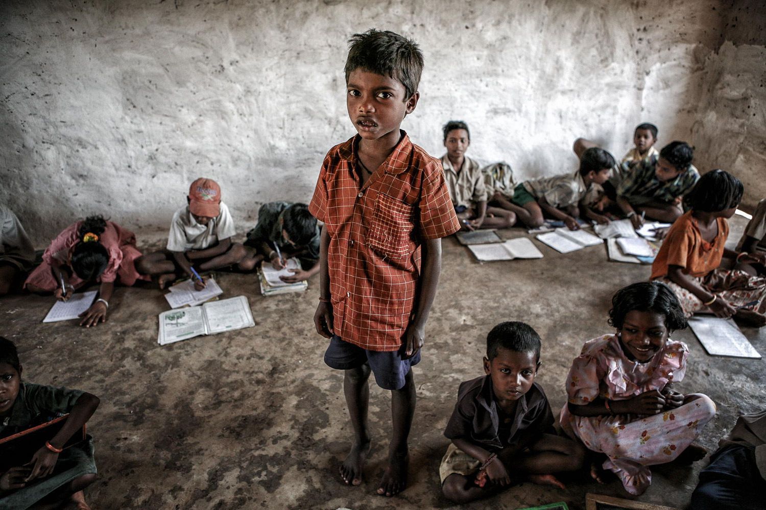 a child standing in a school with poor infrastructure