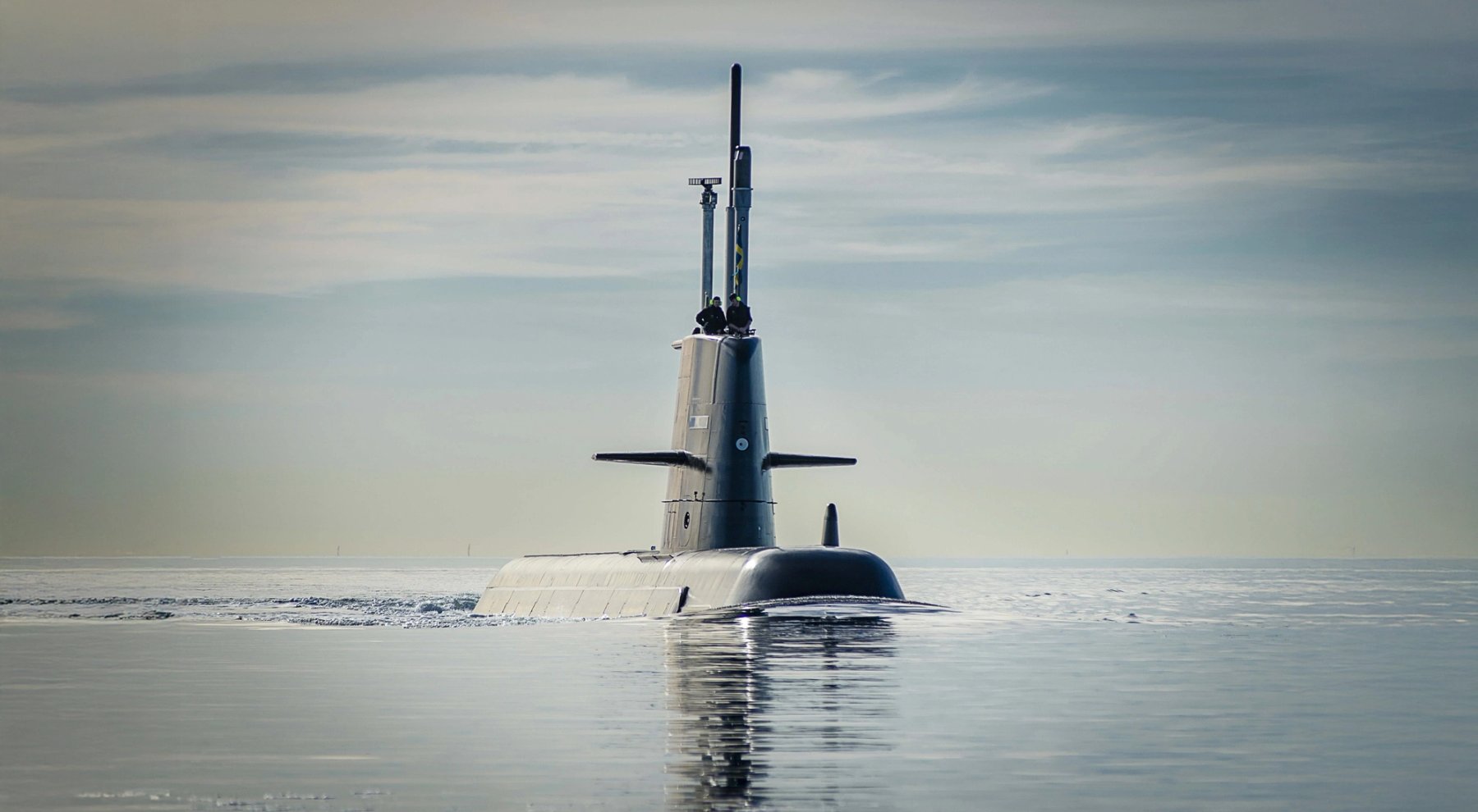 Military submarine surfaced in calm ocean waters