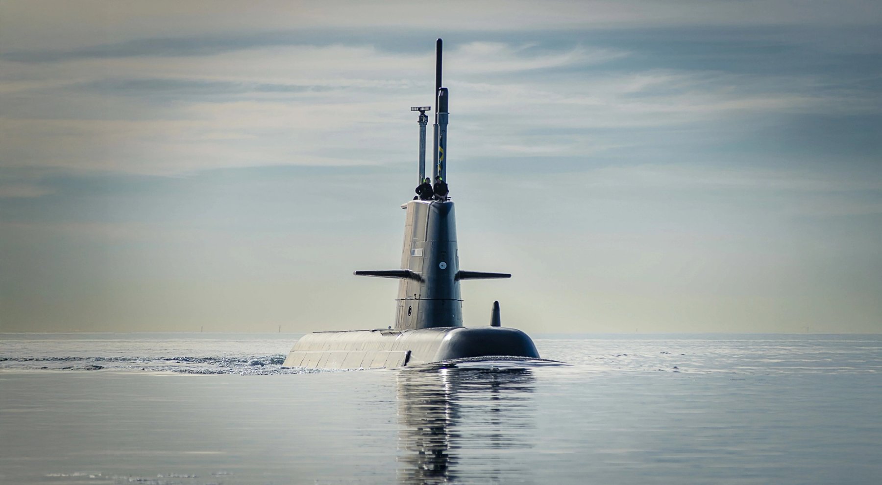 Military submarine surfaced in calm ocean waters