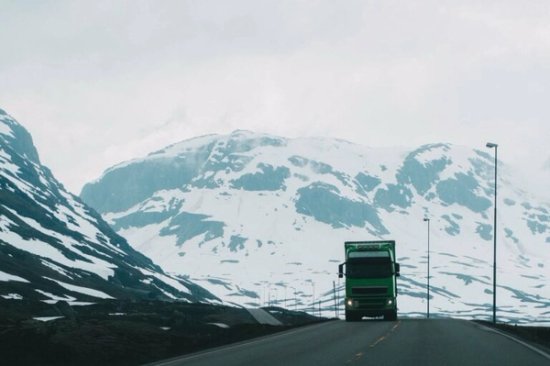 truck driving over mountain pass