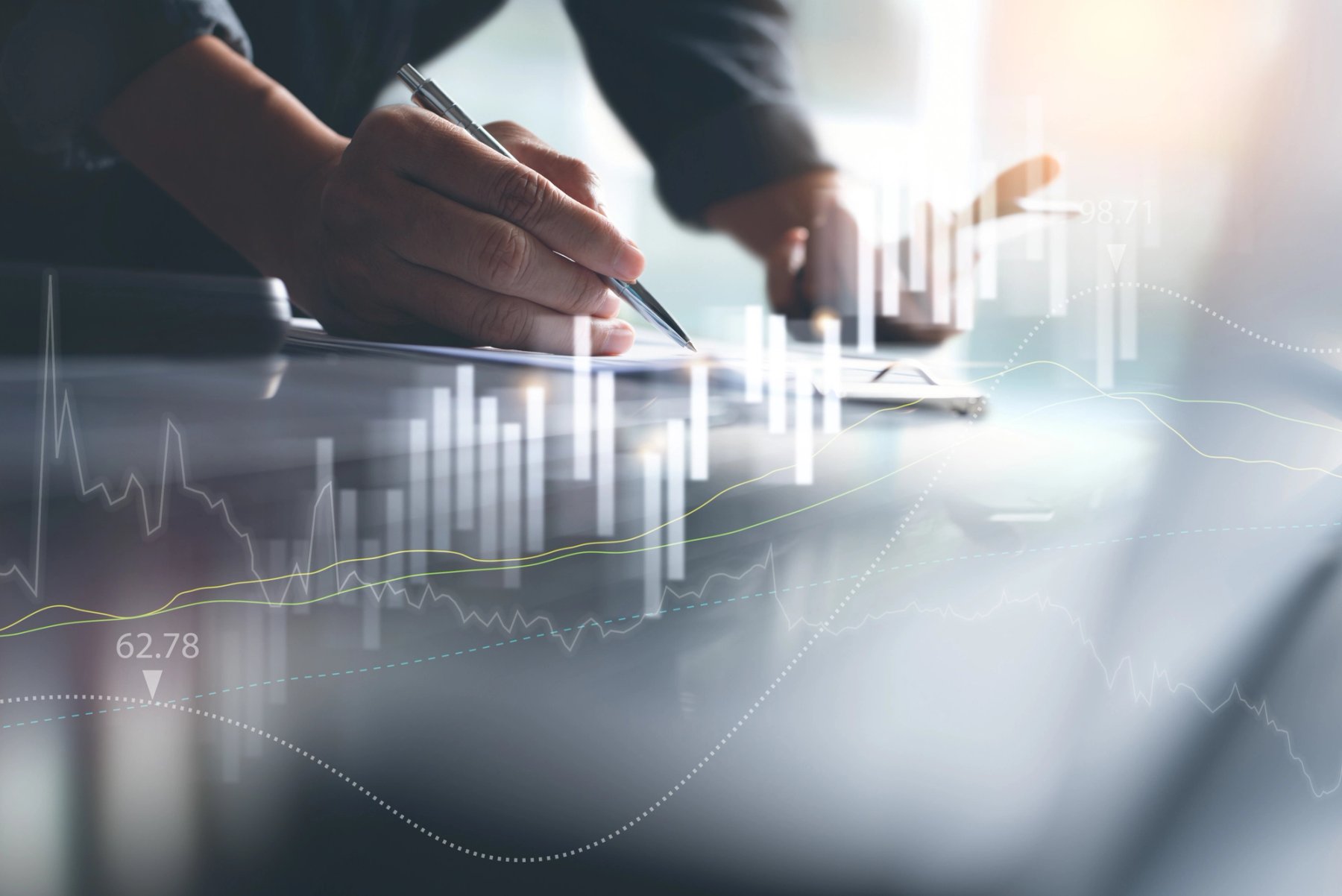 Business professional analyzing financial data with charts overlay