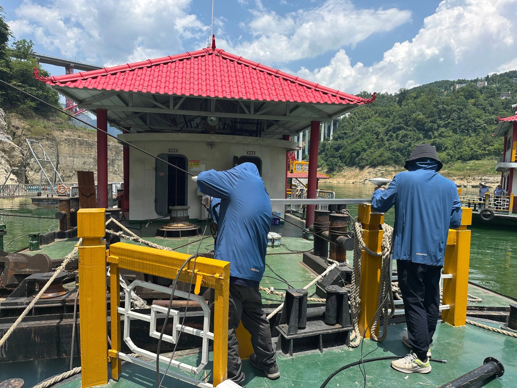 Survey crew operating bathymetric mapping equipment