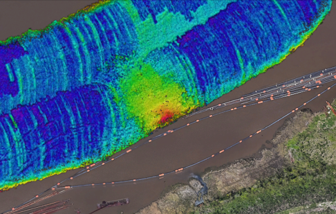 Corresponding low-frequency band cut-out showing the deeper navigable bottom and sub-surface at the outflow pipe, with consolidated material and channel-floor features visibly permeating into the channel.