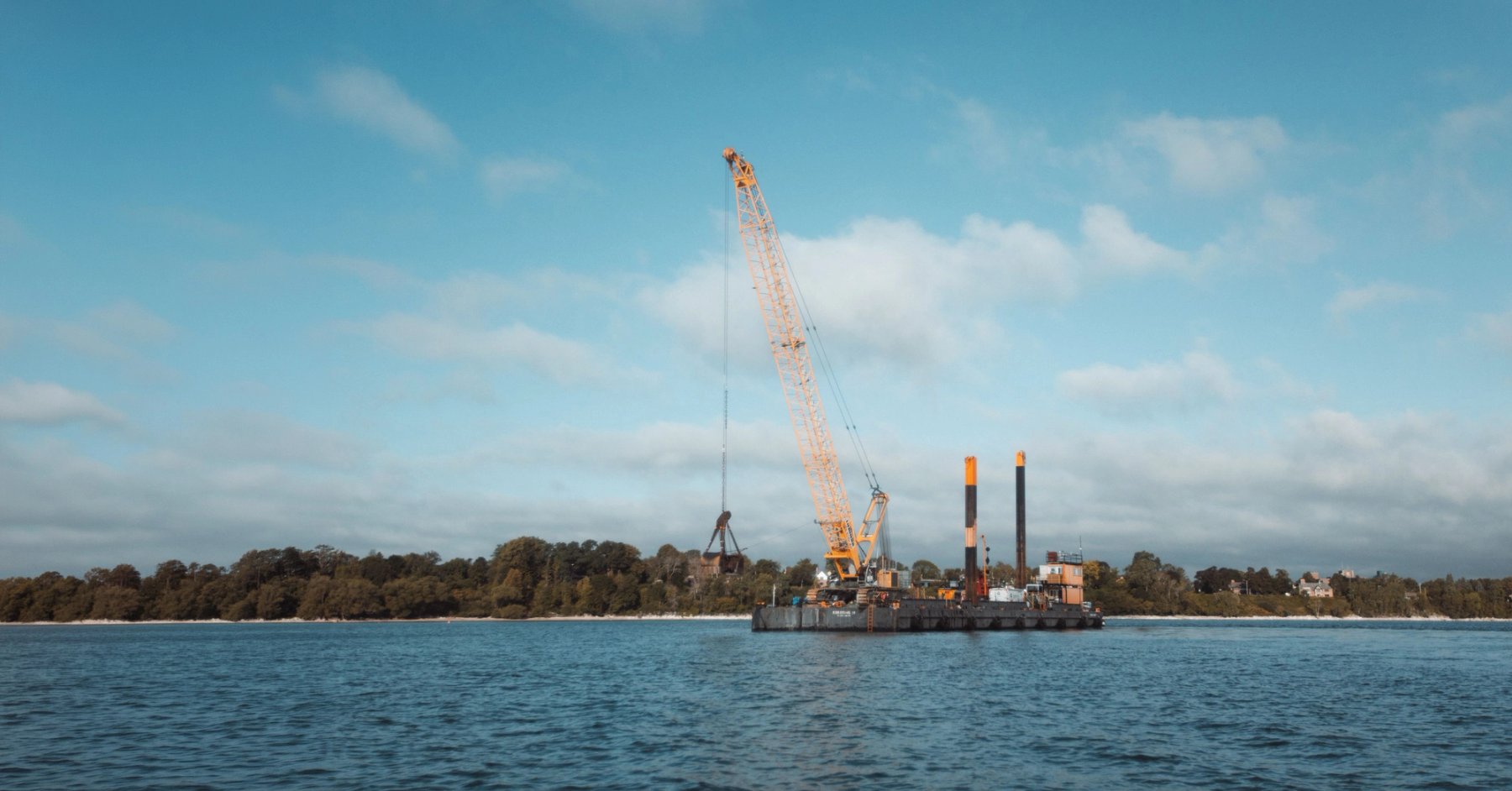 Construction barge with crane for marine dredging operations