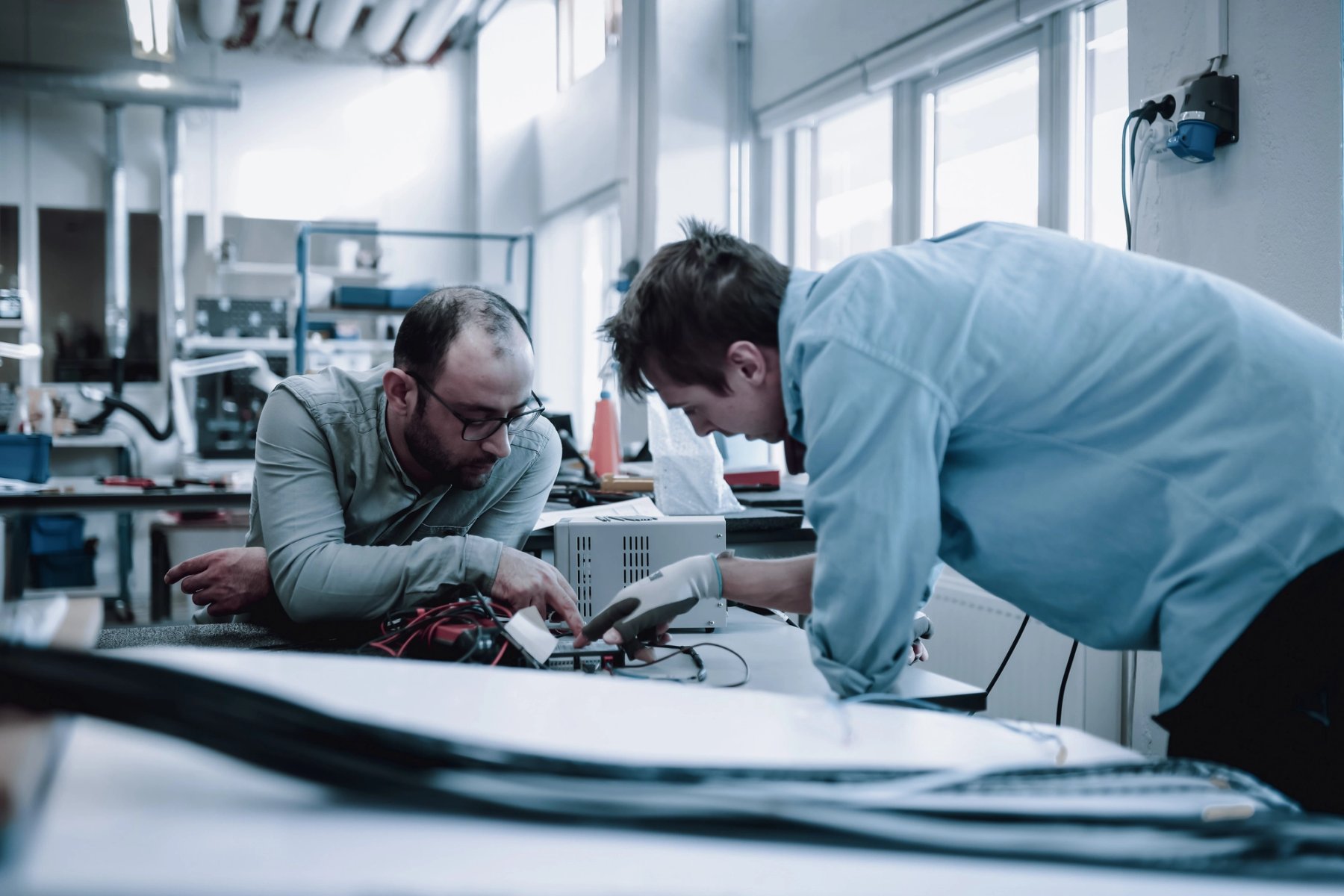 Two R&D engineers working on a component