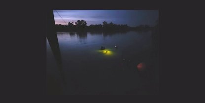 Divers in water at night time