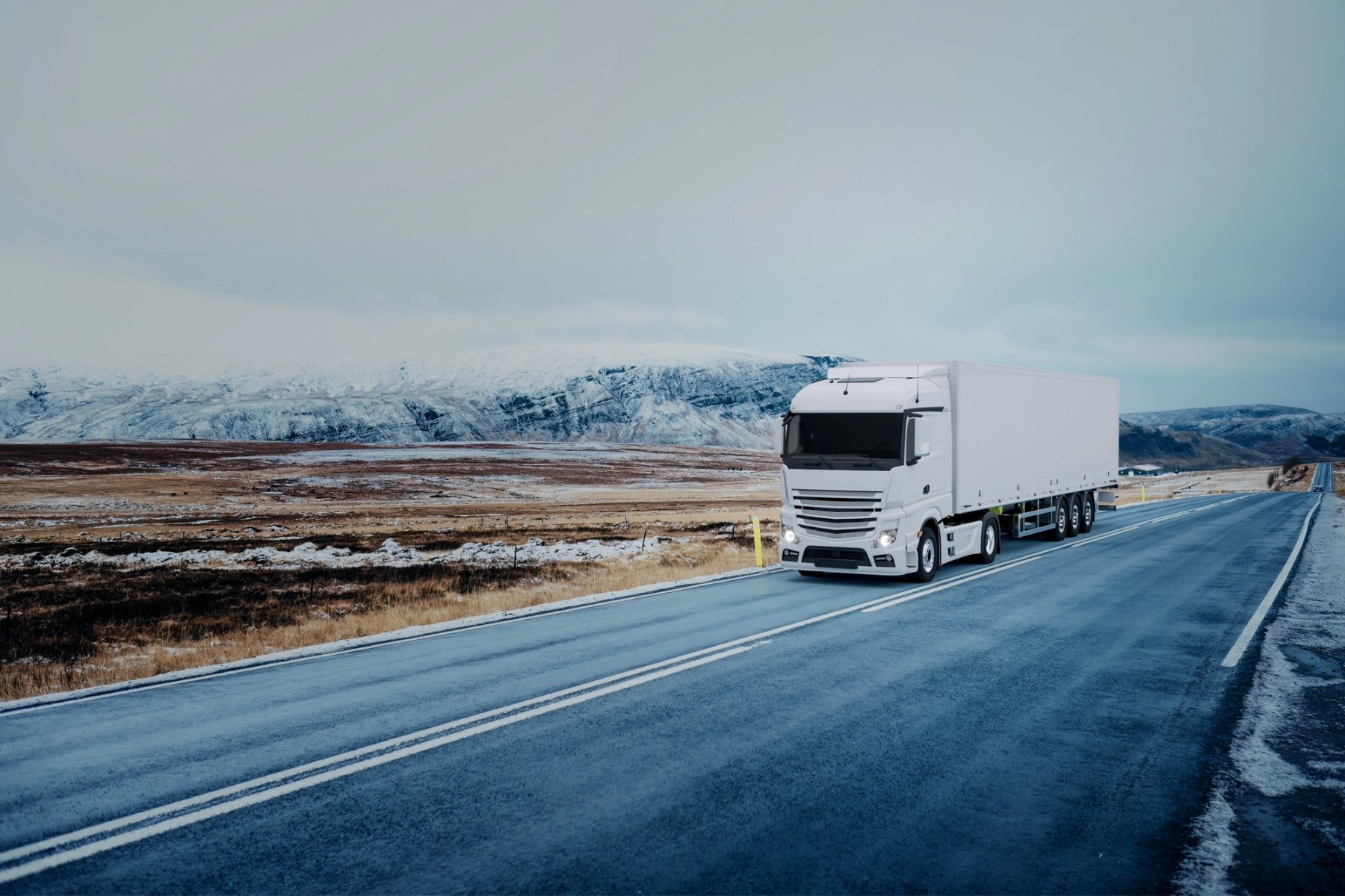 white truck driving through deserted landscape