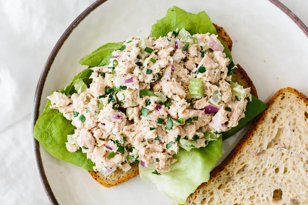Tuna salad on toast with lettuce.