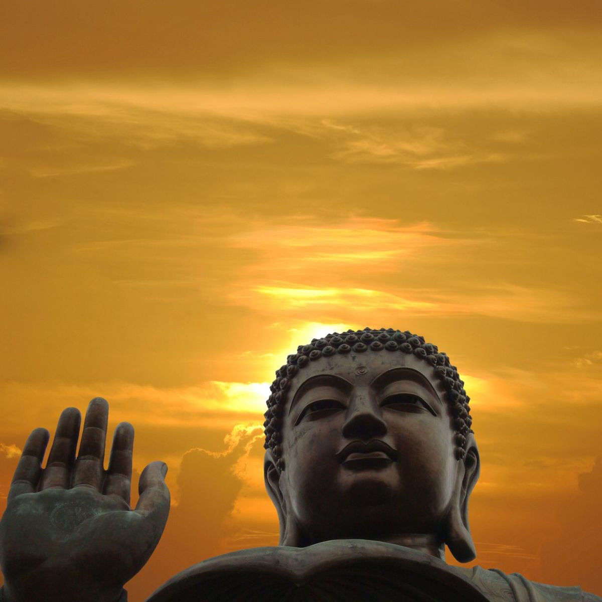 A Buddha figure in the sunrise.