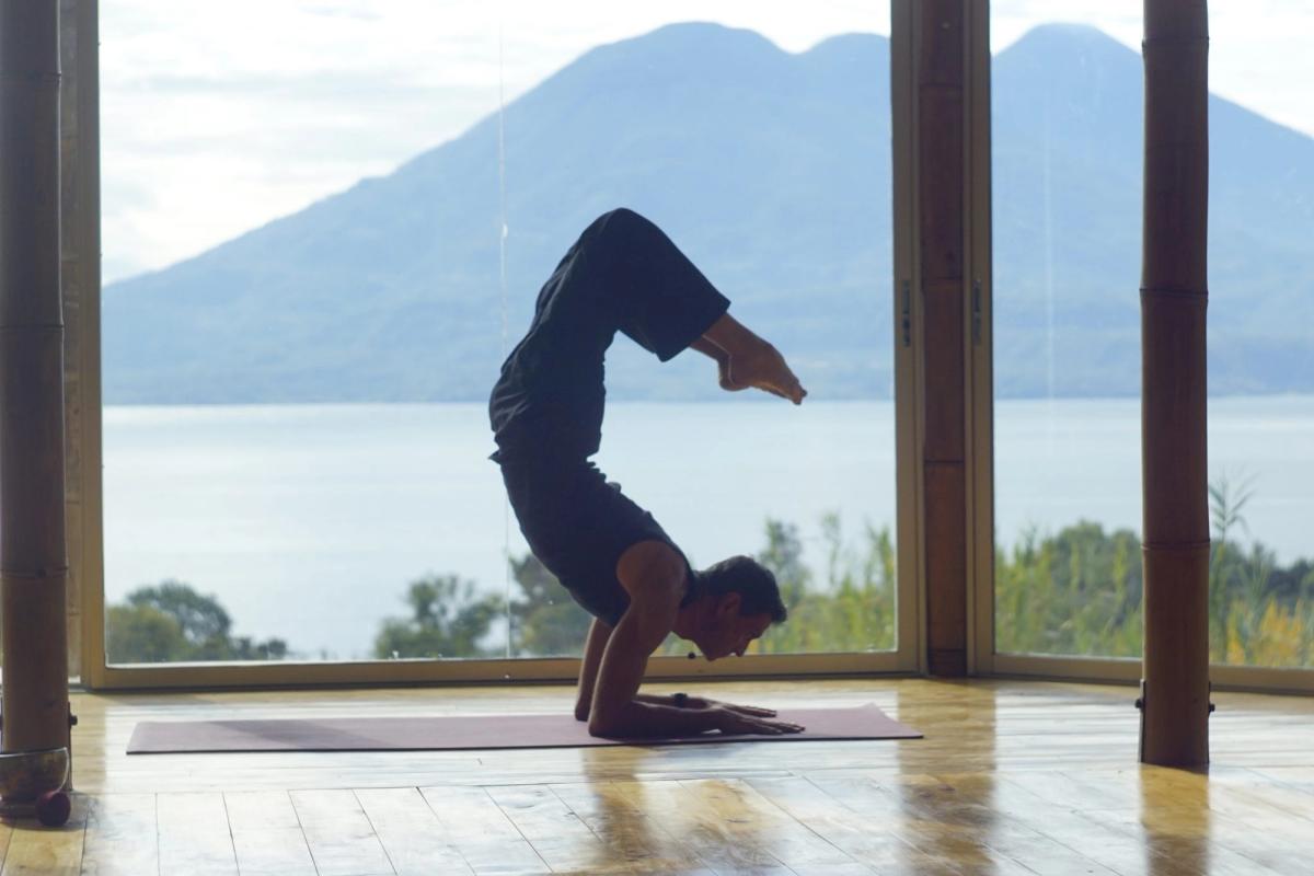 A forearm balance in the shala, lake and volcano behind