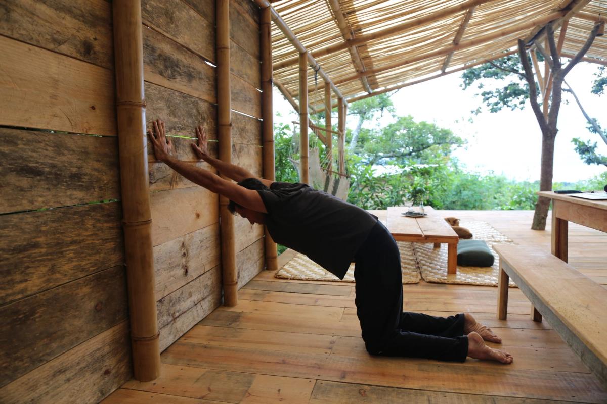 Doron stretching the shoulders on the wooden deck