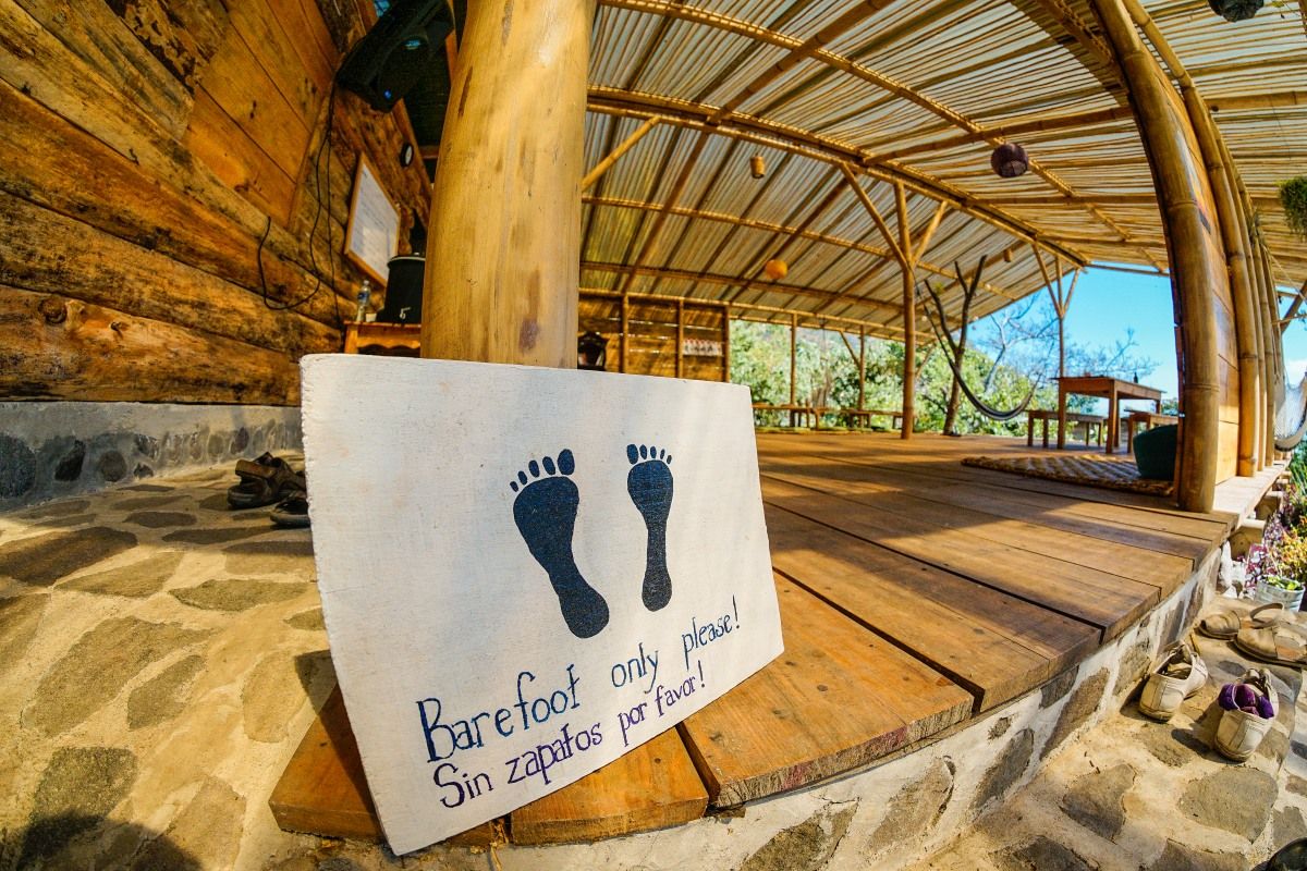 A barefoot sign at the entrance of a yoga space.
