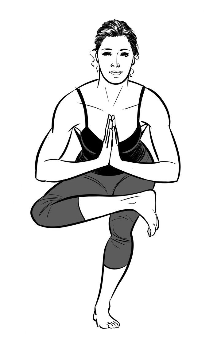 Anjali mudra, palms together at the heart, in tree pose.