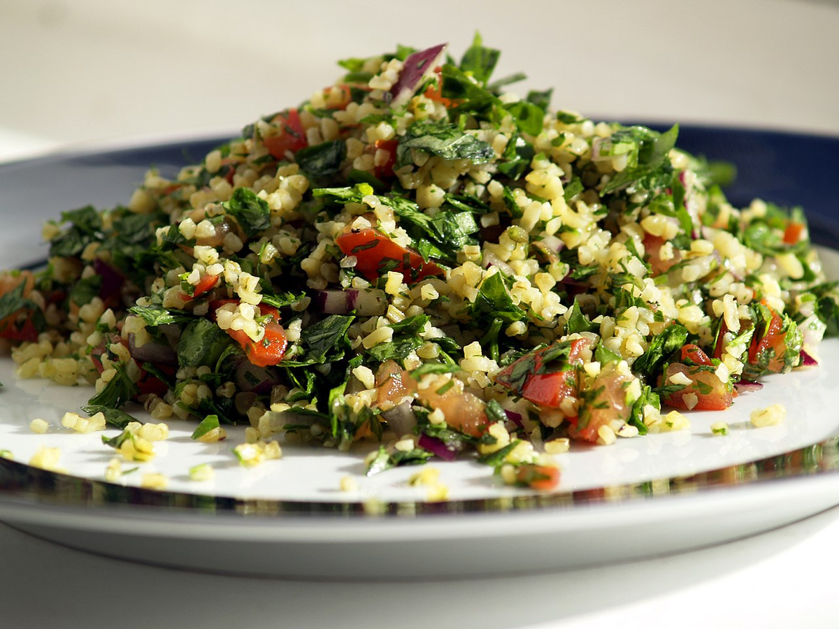 A chopped herb salad with tomato and onion.