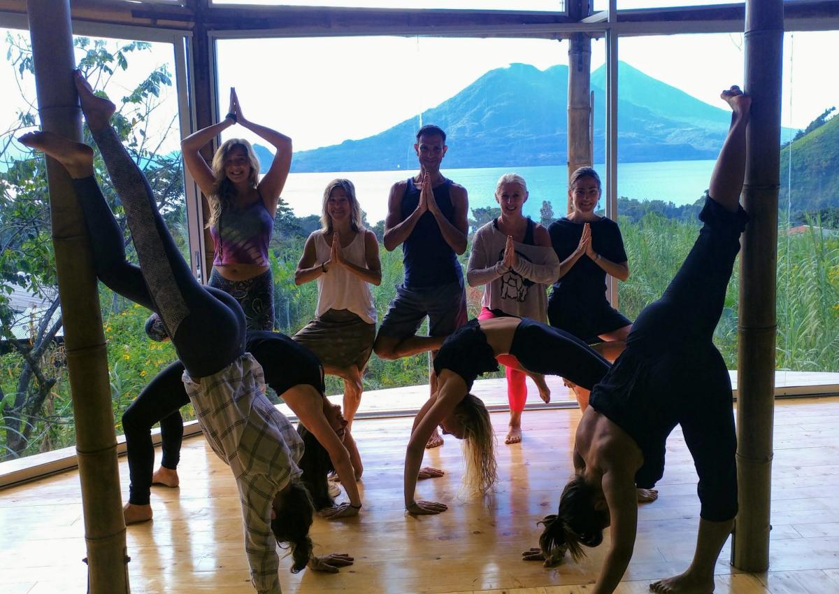 A class in downward-facing dog in the shala.