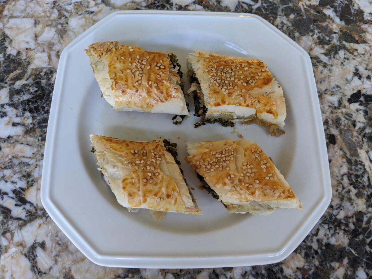 Savory phyllo triangles on a plate.