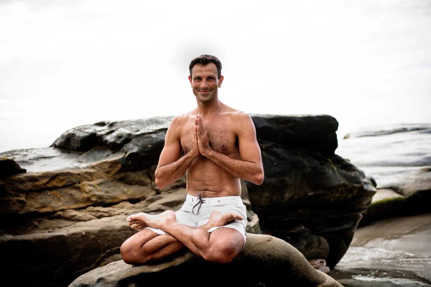 Doron seated in meditation on the rocks