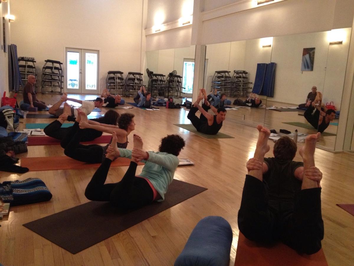 A class practicing boat pose.