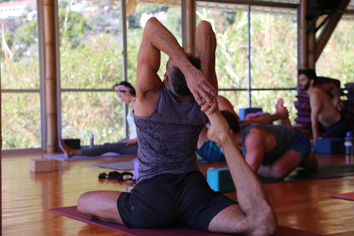 A deep pigeon pose, back foot held overhead.