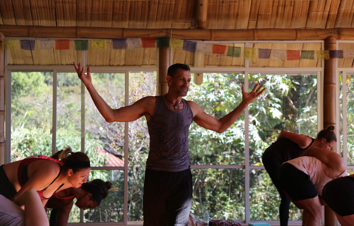 Doron teaching while students fold forward.