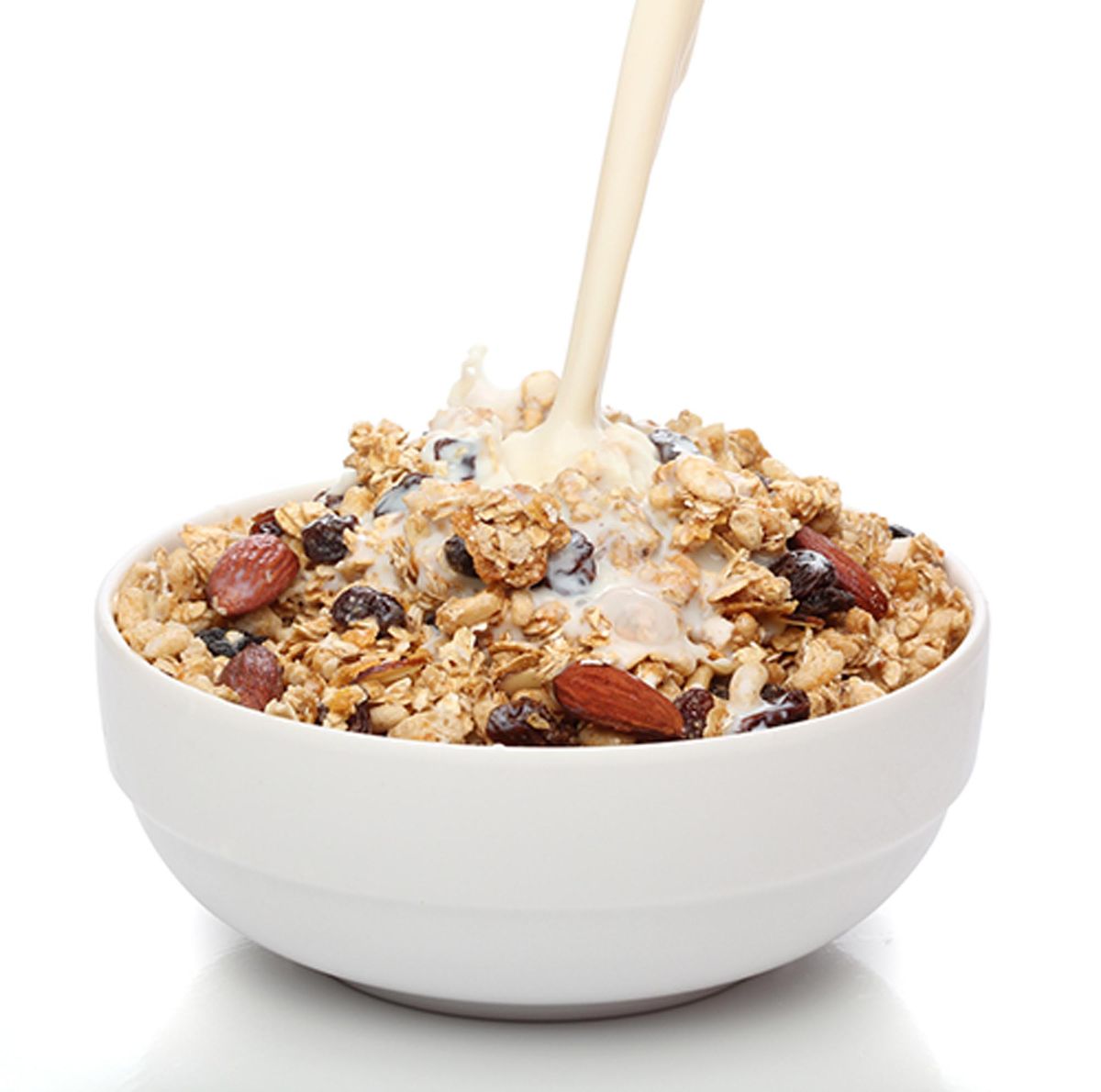 A bowl of oatmeal topped with fruit and nuts.