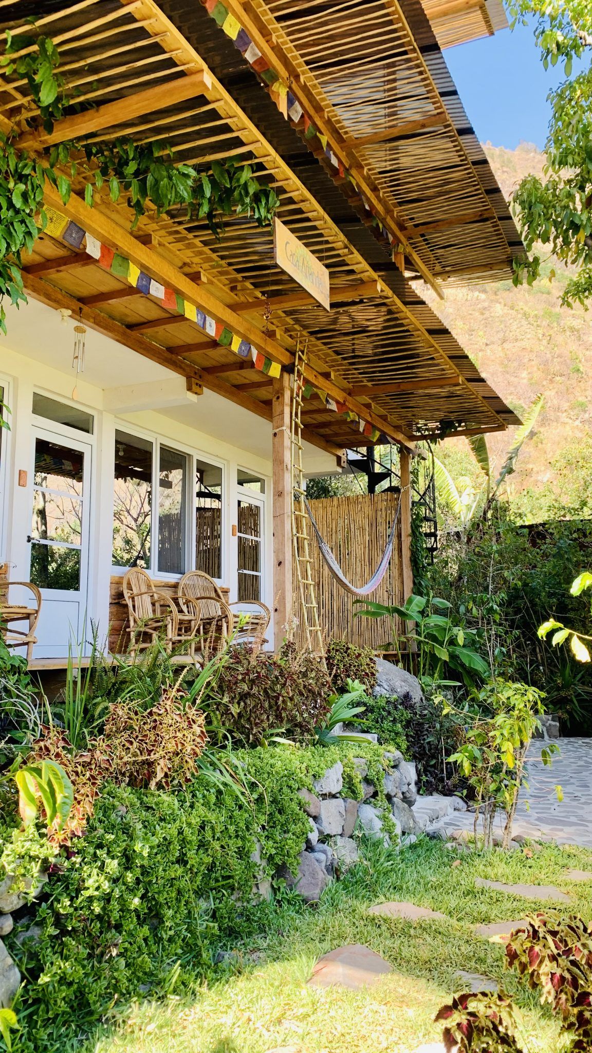 A wooden porch with a hammock, set up for daily practice.