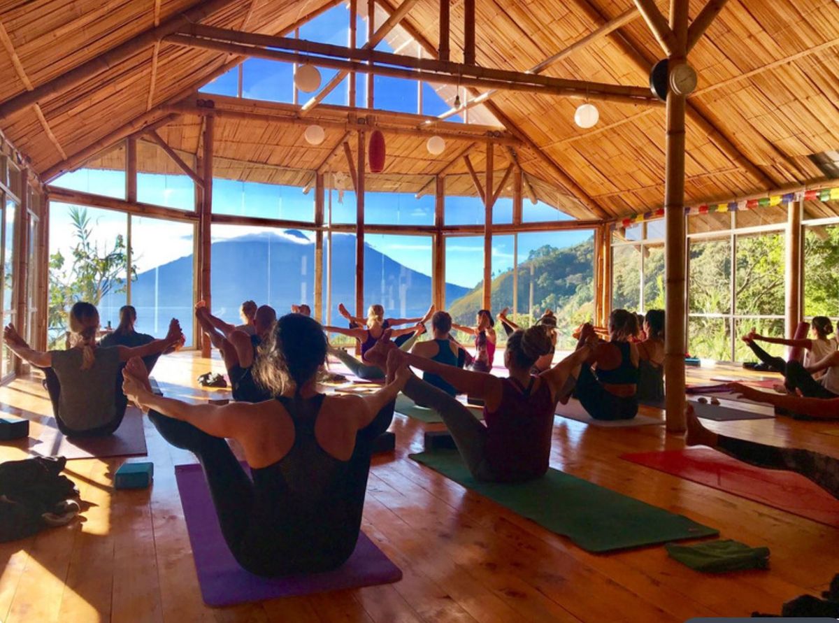 A class with arms lifted overhead.