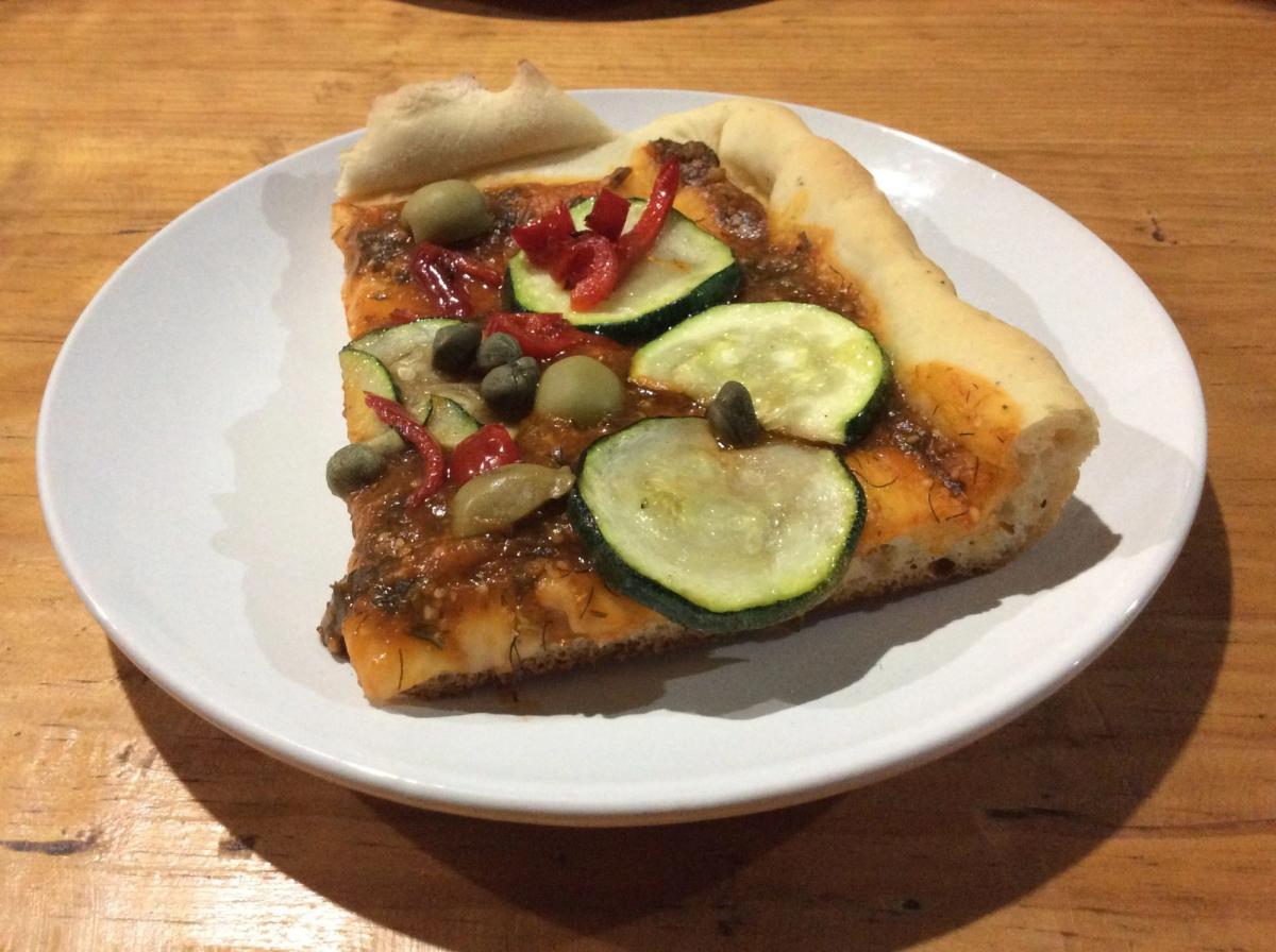 A piece of fish with zucchini and carrot.