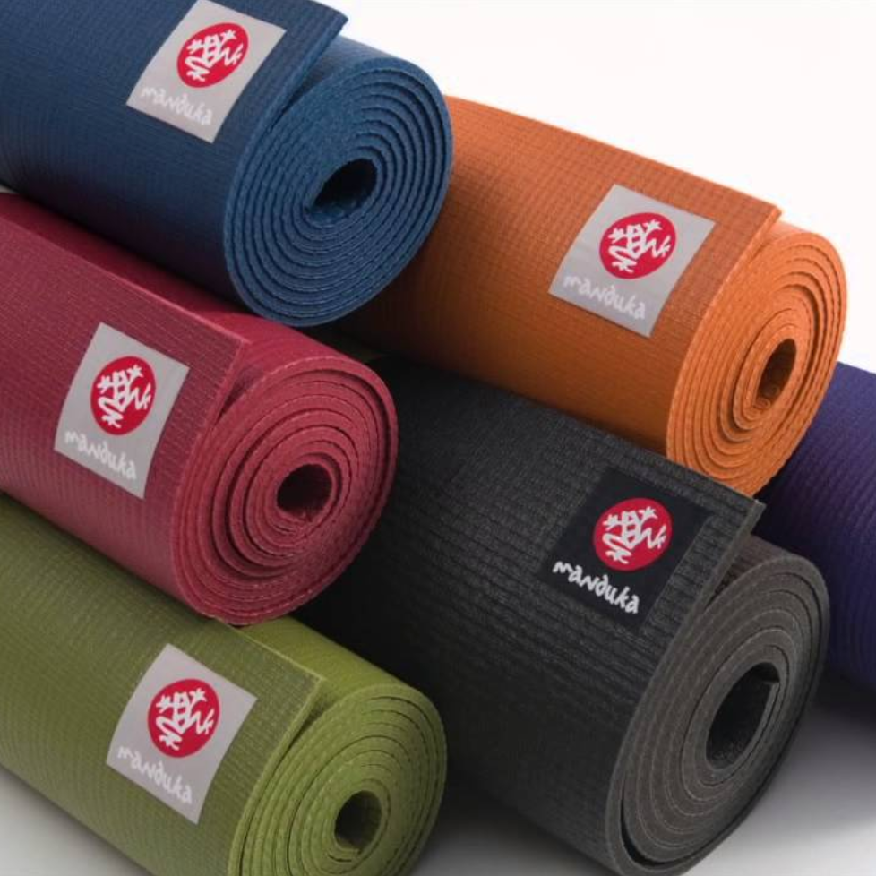 Rolled yoga mats in several colors.