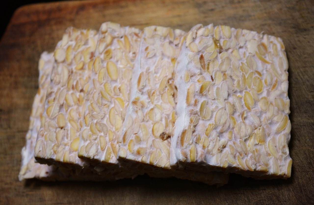 Slices of tempeh on a wooden board