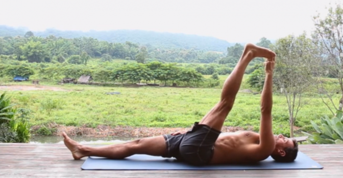 A supine stretch, holding one leg up.