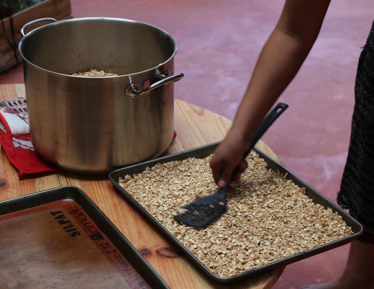 A pot of pale grains cooking on a stove.