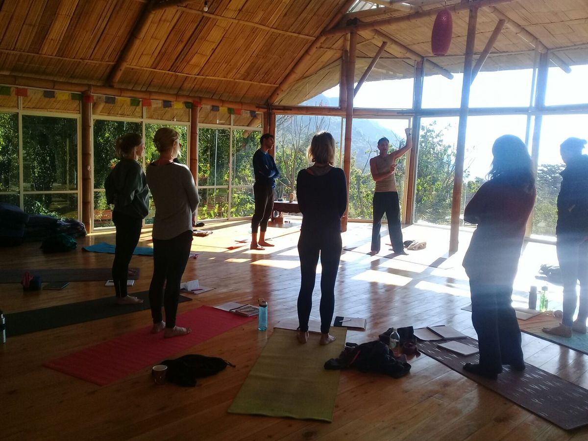 A standing yoga class in the shala.