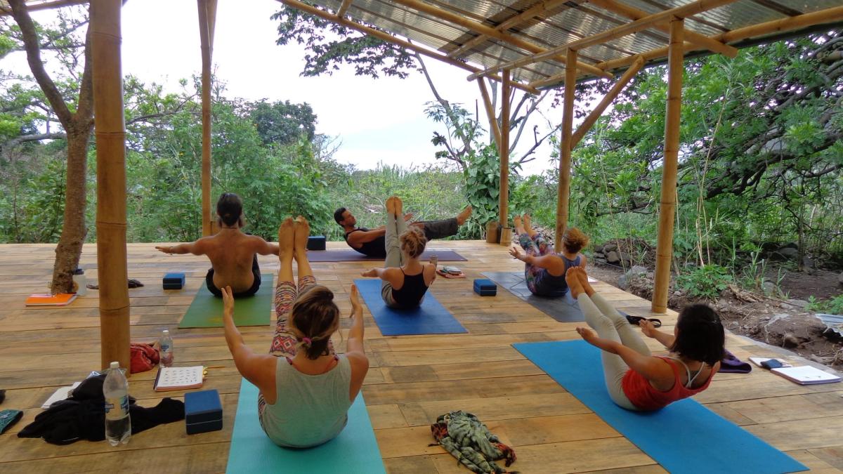A class seated for meditation in the shala.