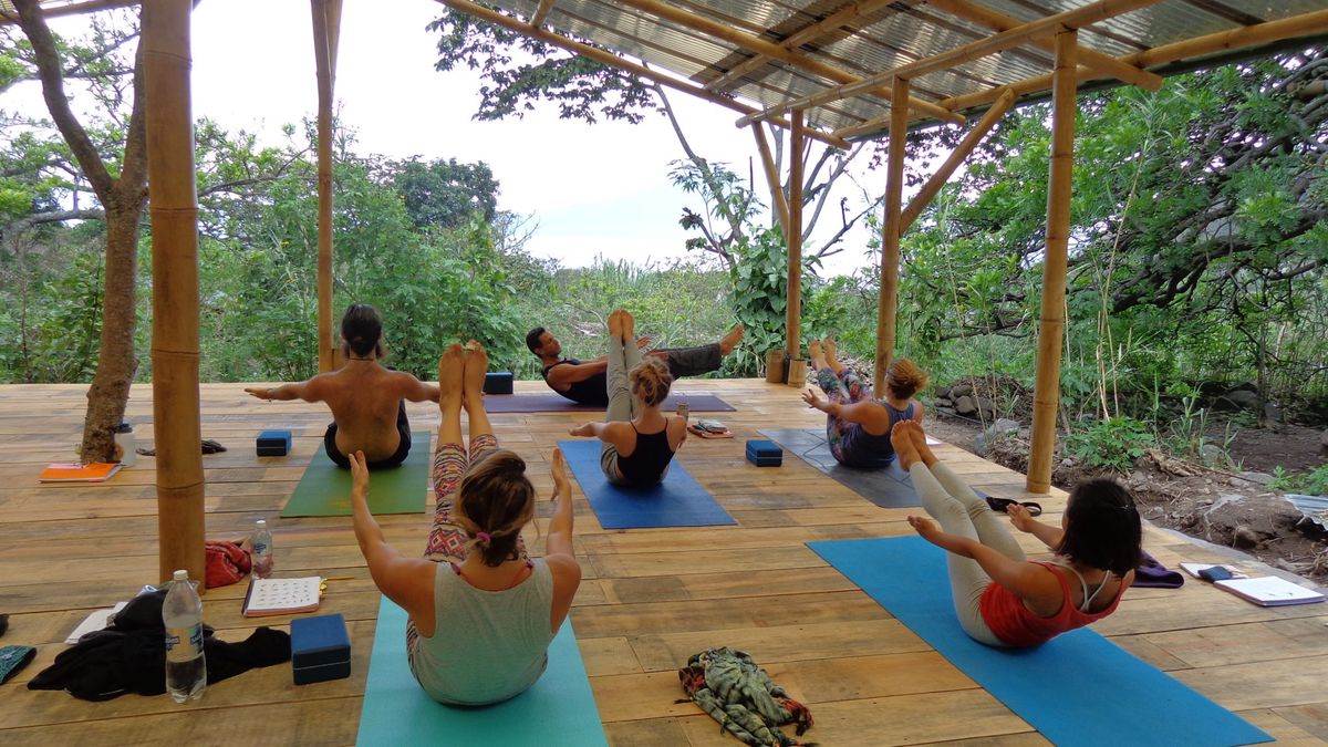 A class seated for meditation in the shala.