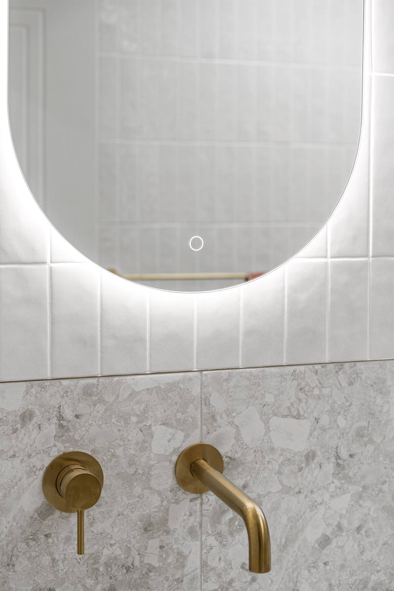 Frameless glass shower with brass fixtures alongside basin and mirror in Wahroonga ensuite
