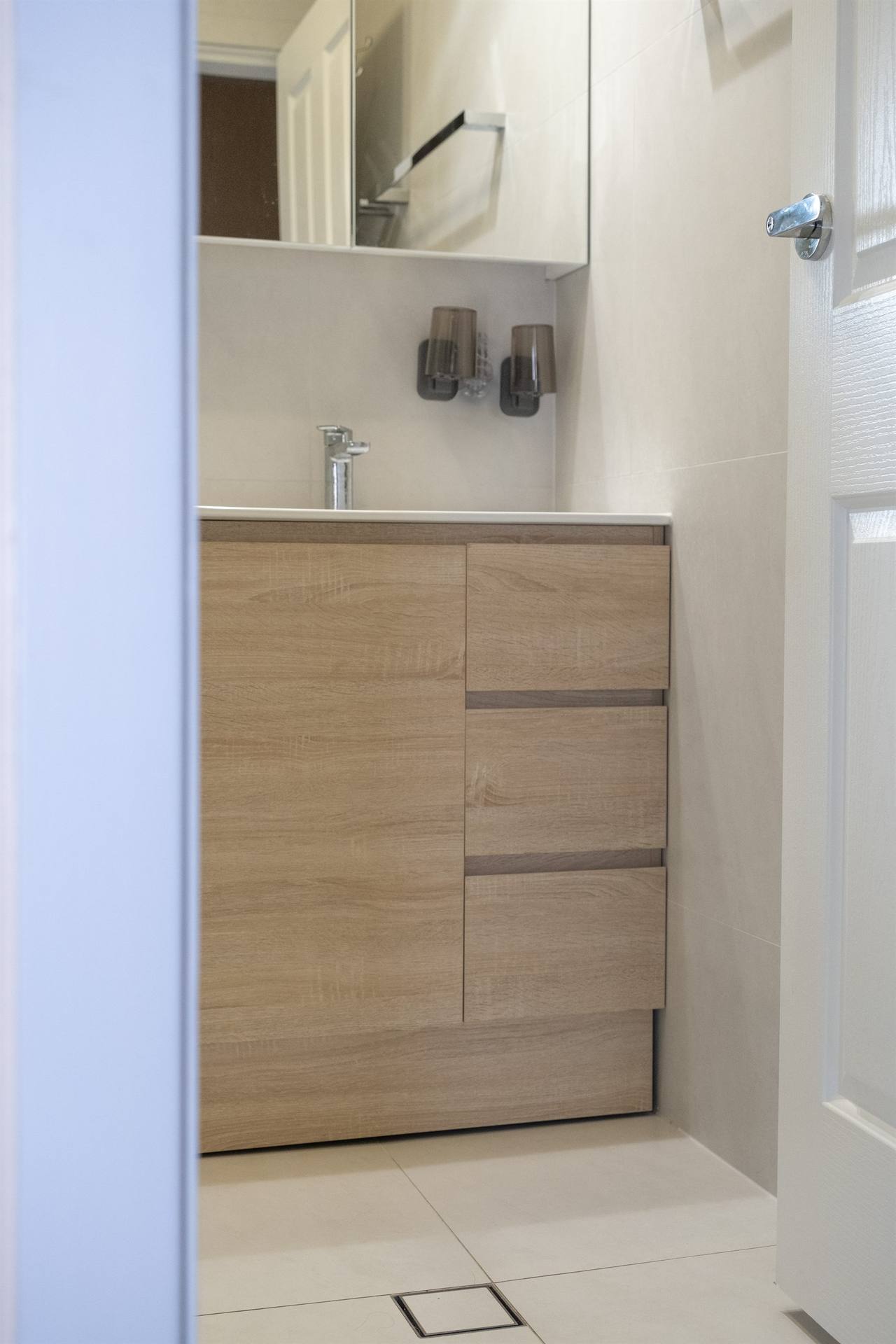 Timber-veneer custom vanity with chrome tap in Bexley bathroom renovation